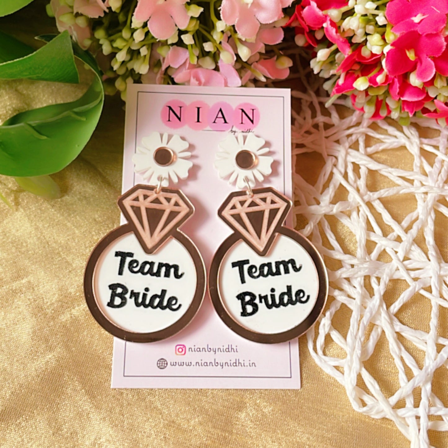 Team Bride Floral Earrings - Rosegold and White - Nian by Nidhi - placed in a colorful background