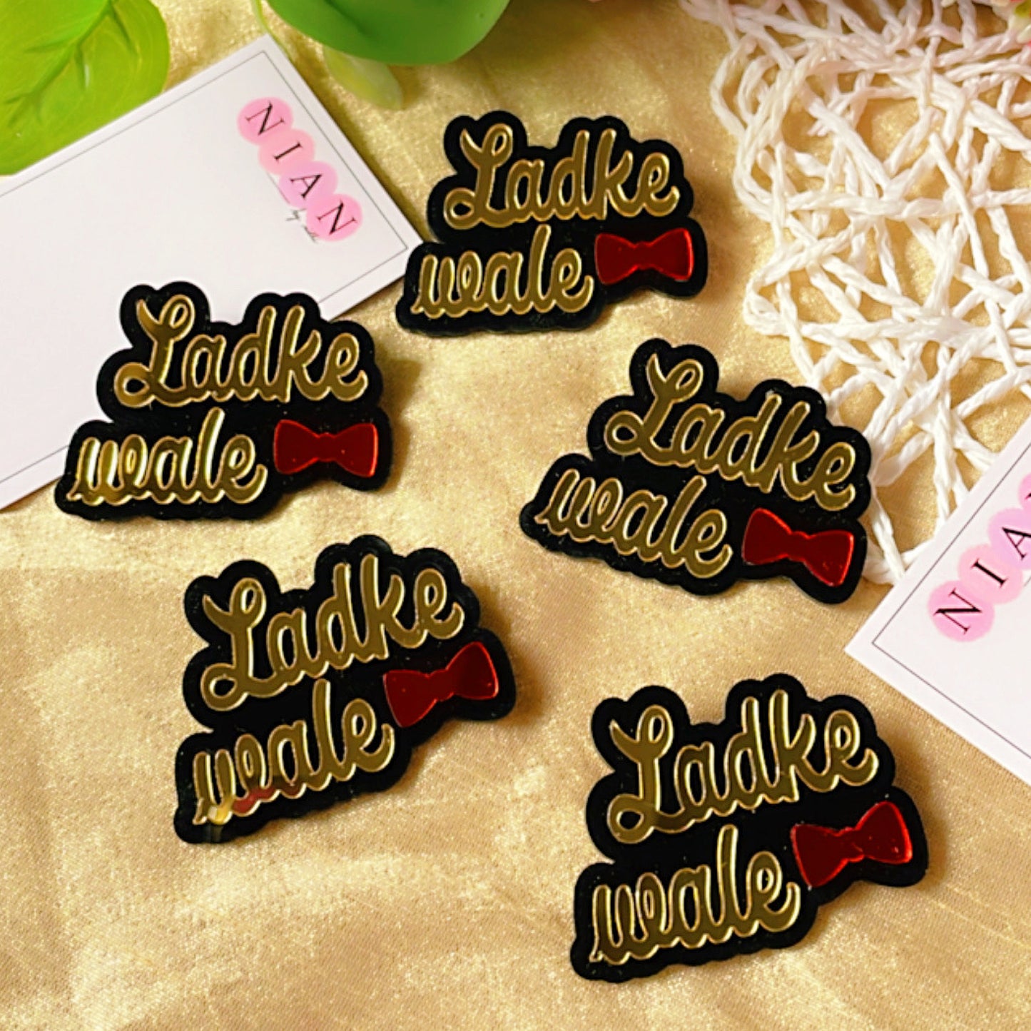 Ladke Vale Brooch Pin - Glossy Golden and Red - Nian by Nidhi - placed in a colorful background