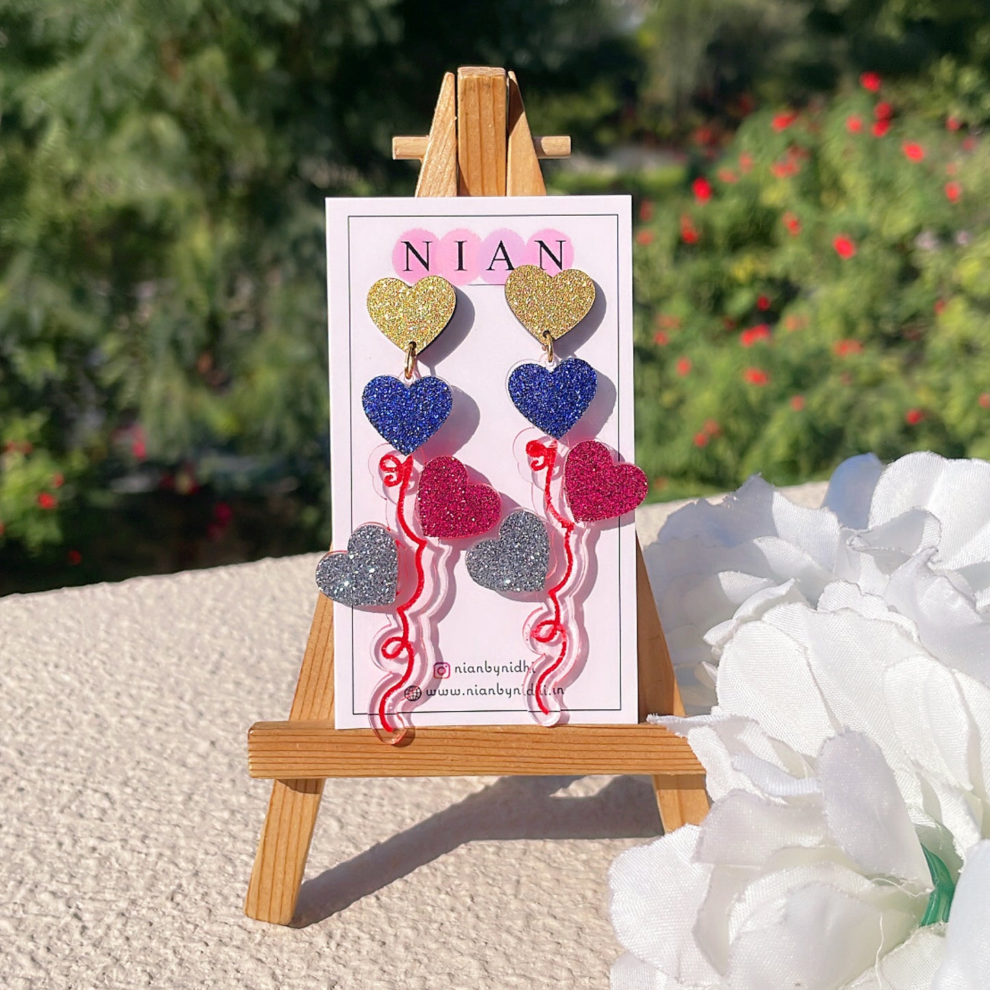 Balloon Bouquet Earrings - Shimmer Golden, Shimmer Blue, Shimmer Maroon, Shimmer Silver - Nian by Nidhi - placed in a green and white background