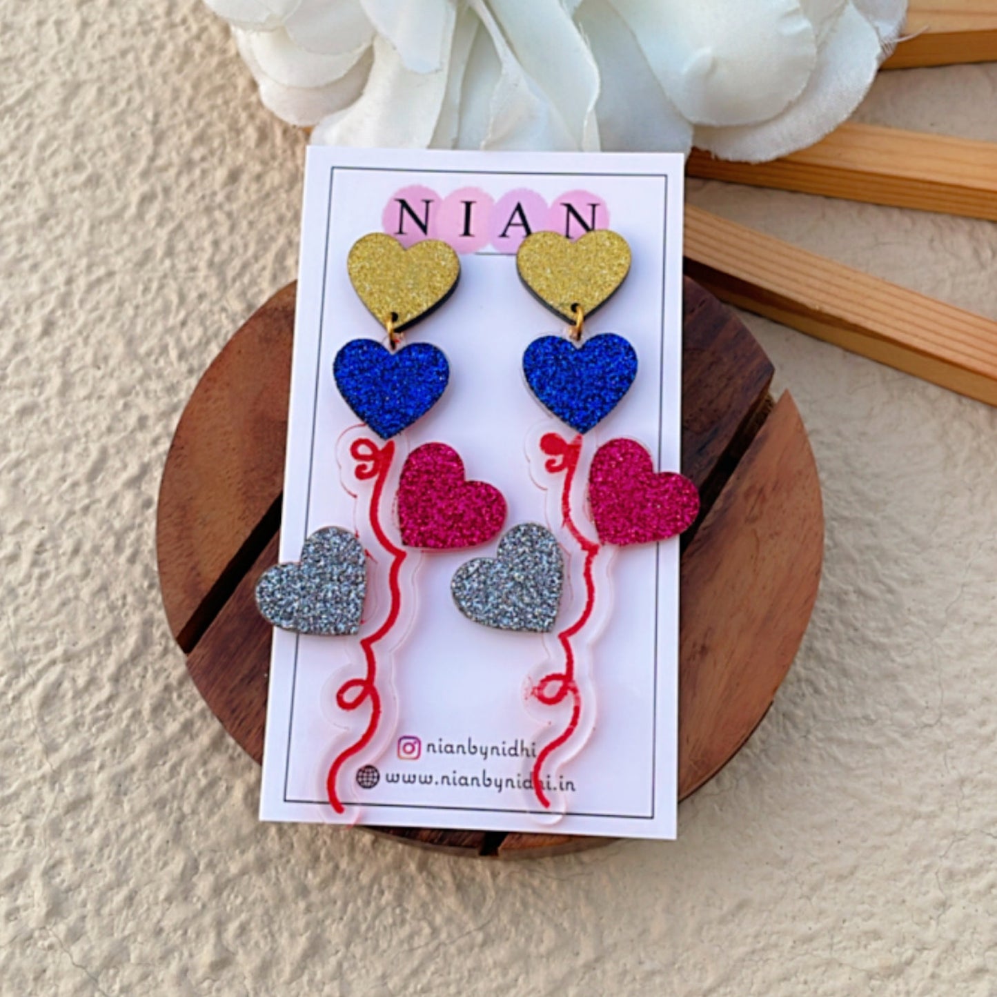 Balloon Bouquet Earrings - Shimmer Golden, Shimmer Blue, Shimmer Maroon, Shimmer Silver - Nian by Nidhi - placed in a brown background