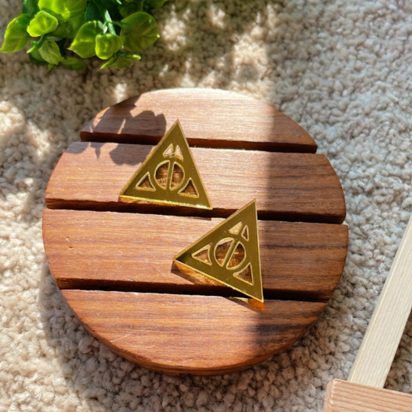 Deathly Hallows Studs - Glassy Golden - Nian by Nidhi - placed in a light beige background