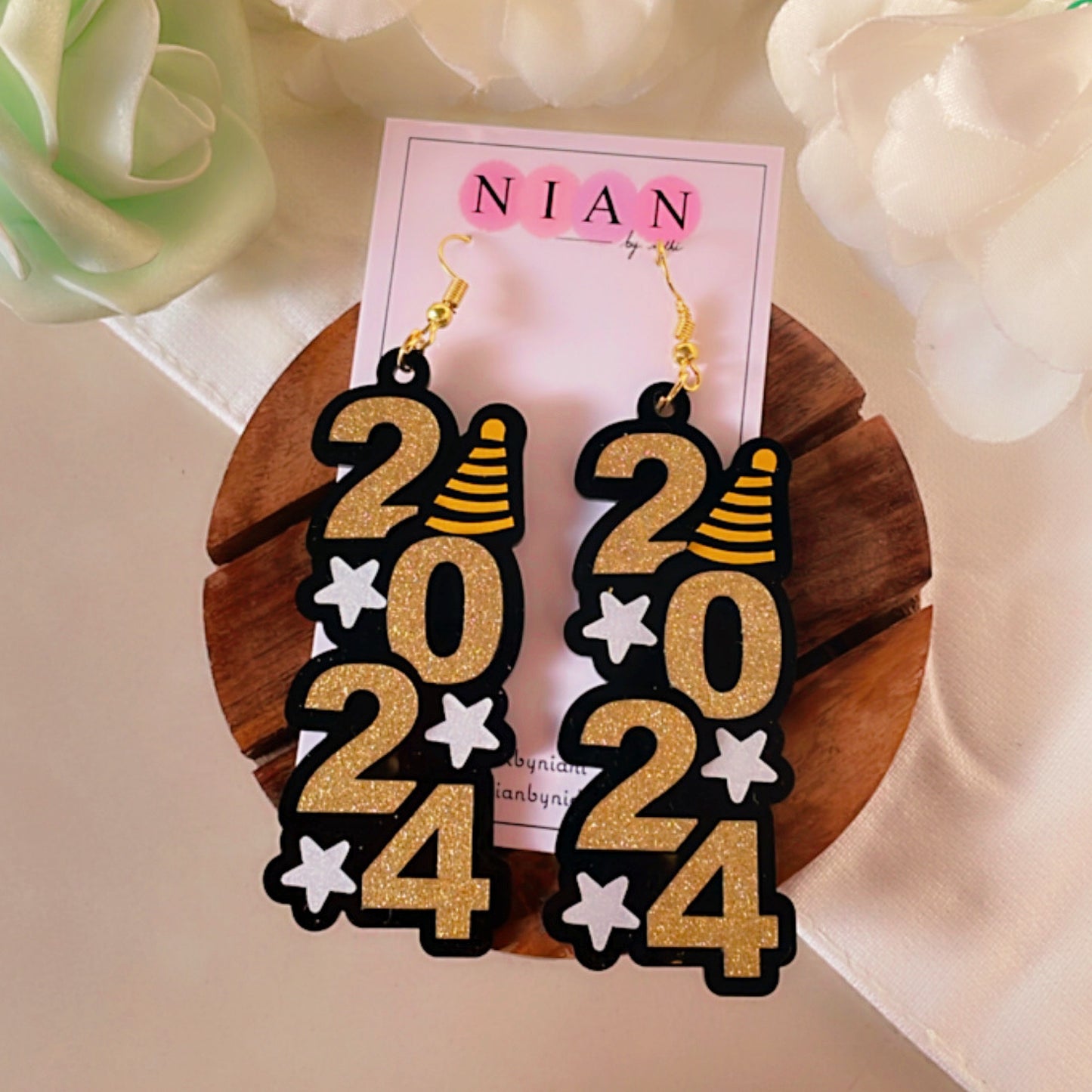 ⁠2024 Danglers - Shimmer Golden and White - Nian by Nidhi - placed in a white flowery background