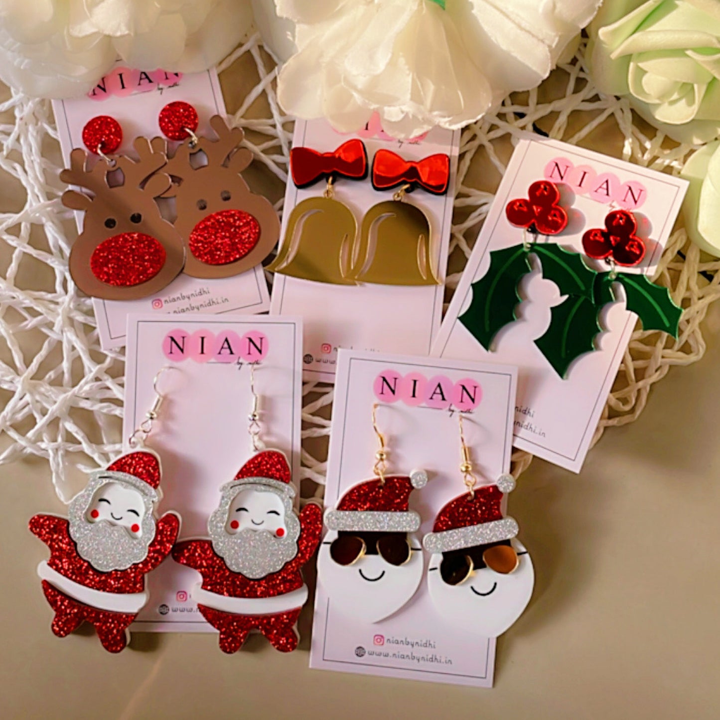Christmas Carnival Curation (Set of 5) - Nian by Nidhi - consists 5 earrings with a Christmas theme - placed in a light flowery background