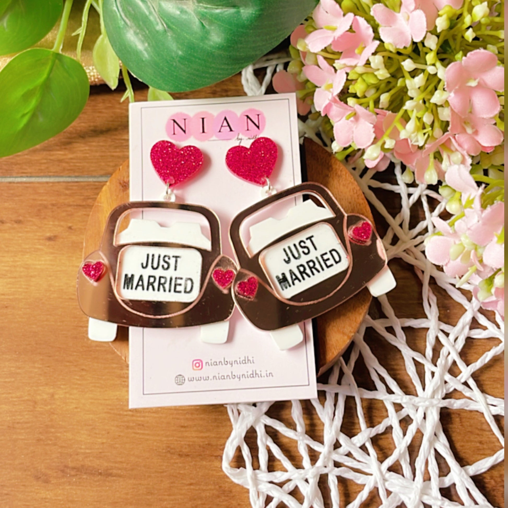 Just Married Earrings - Rosegold, White, and Shimmer Magenta - Nian by Nidhi - placed in a colorful background
