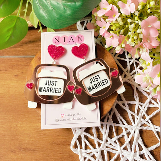 Just Married Earrings - Rosegold, White, and Shimmer Magenta - Nian by Nidhi - placed in a colorful background