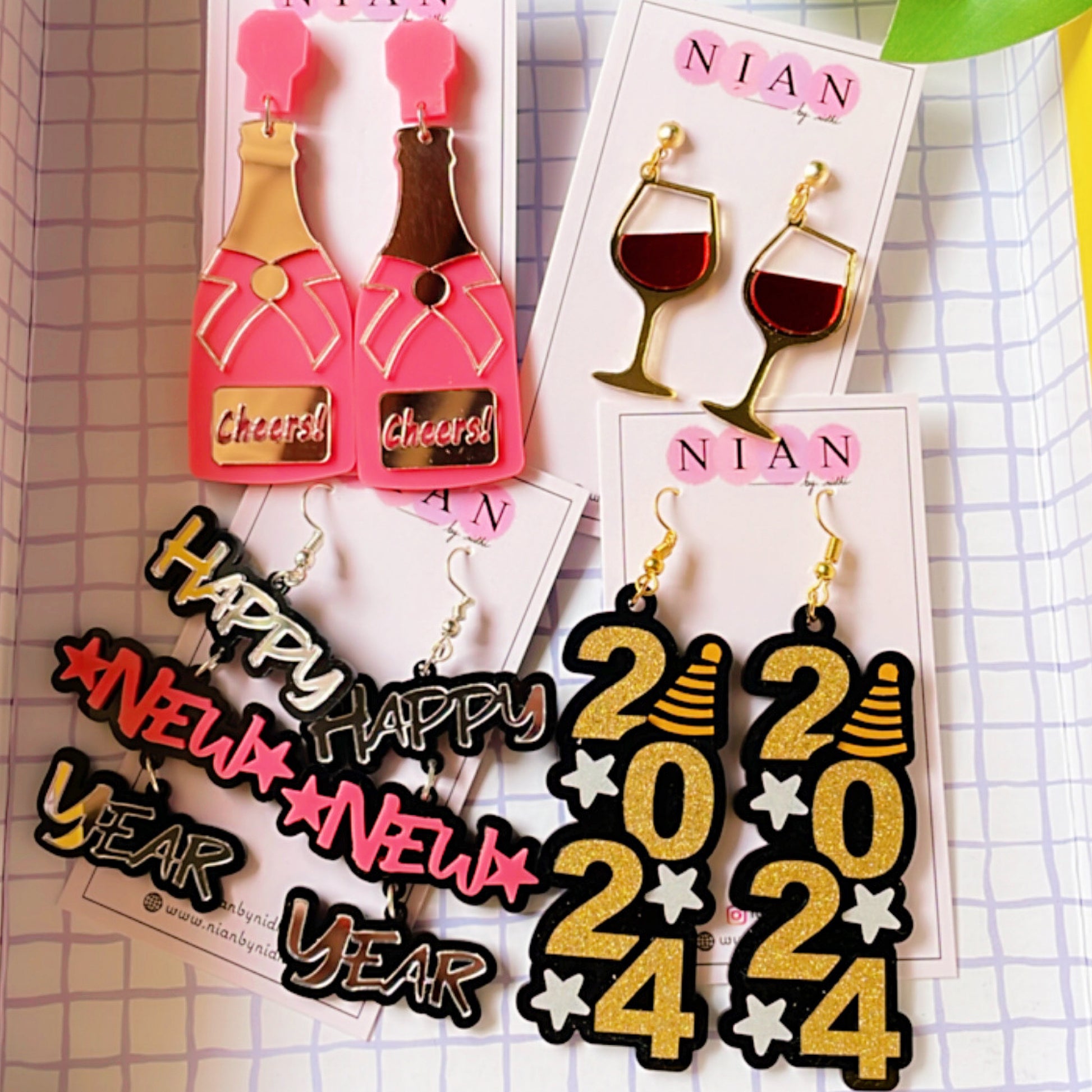 The New Year's Sparkle Set (Set of 4) - consisting of 4 earrings - Nian by Nidhi - placed in a squared-check background