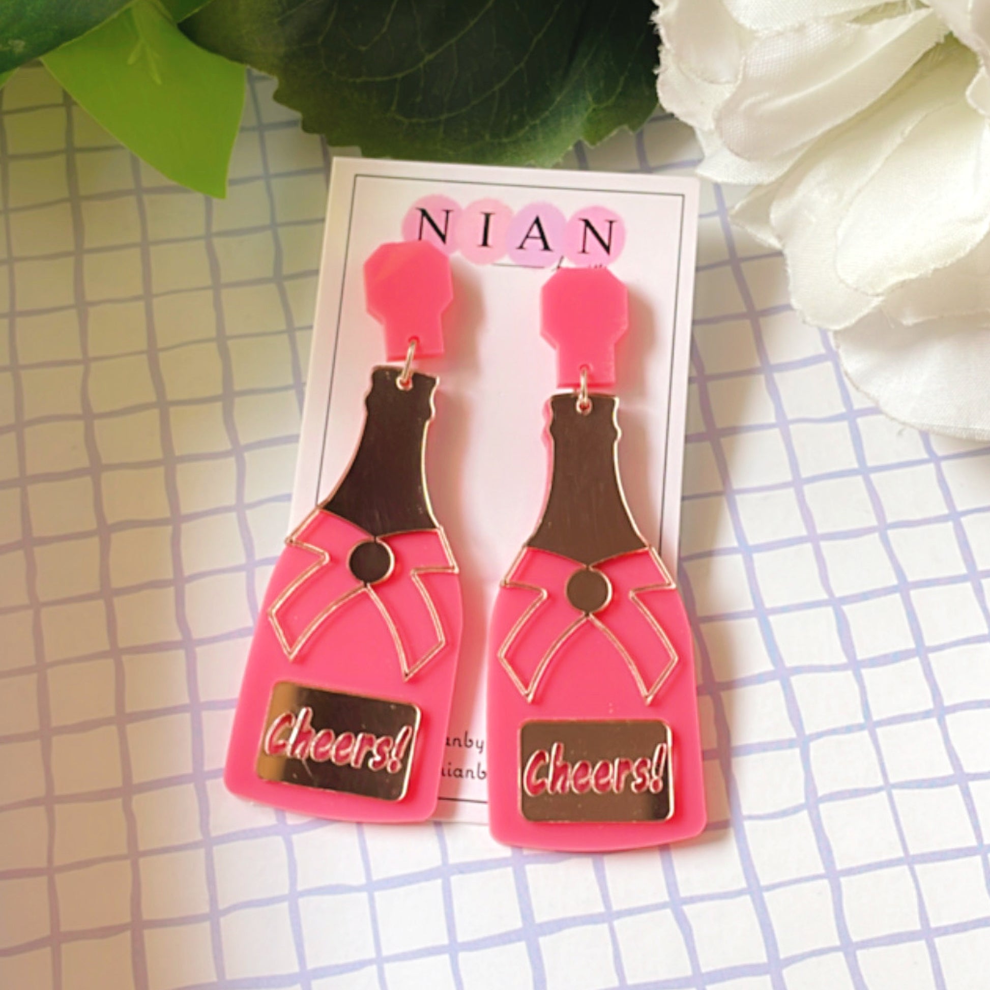⁠Bubbly Cheers Earrings - Pink and Rosegold - Nian by Nidhi - placed in a squared-check background