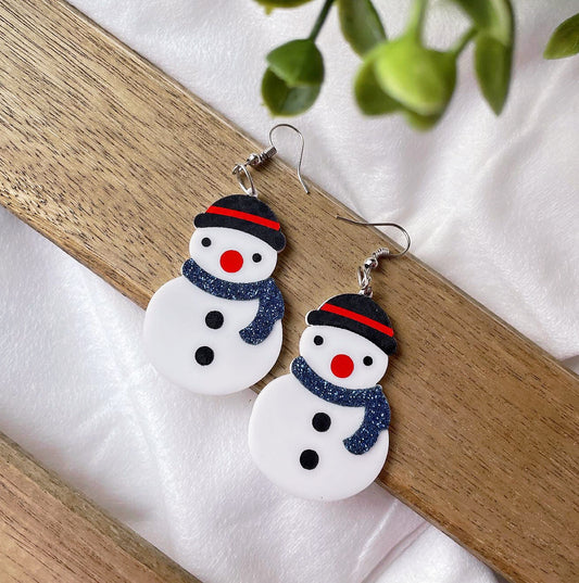 Snowman Earrings - white - Nian by Nidhi - placed in a white and brown background