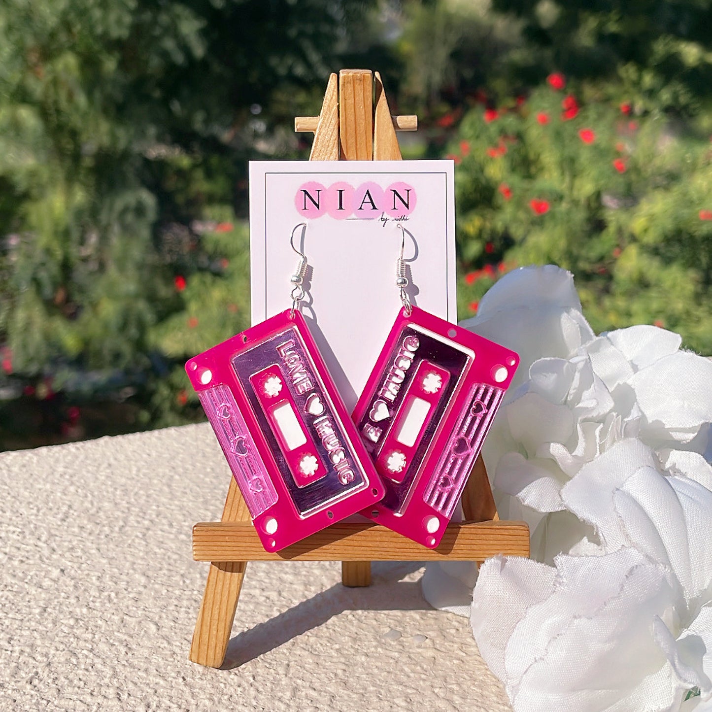 Love Cassette Earrings - Glossy Pink and White - Nian by Nidhi - placed in a white and green background