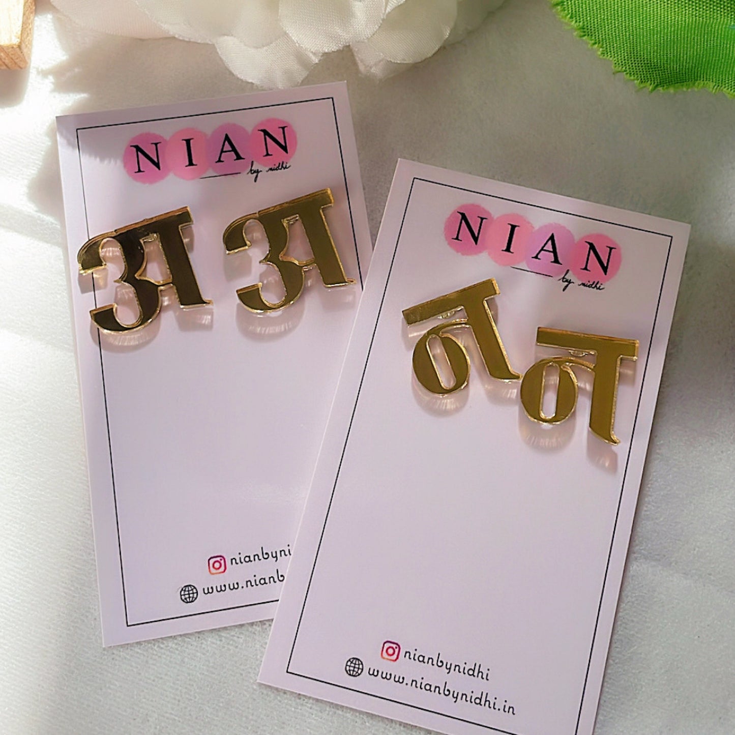Customised Hindi Initial Studs - Glossy Golden - Nian by Nidhi - placed in a white background