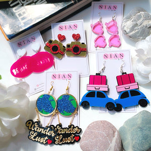 Bon Voyage Combo (Set of 5) - consists 5 multi-colored earrings - Happy Journey Earrings, Wanderlust Earrings, Camera Earrings, Be Happy Be Sassy Earrings, and Glam Goggles Earrings - Nian by Nidhi - placed in a white background