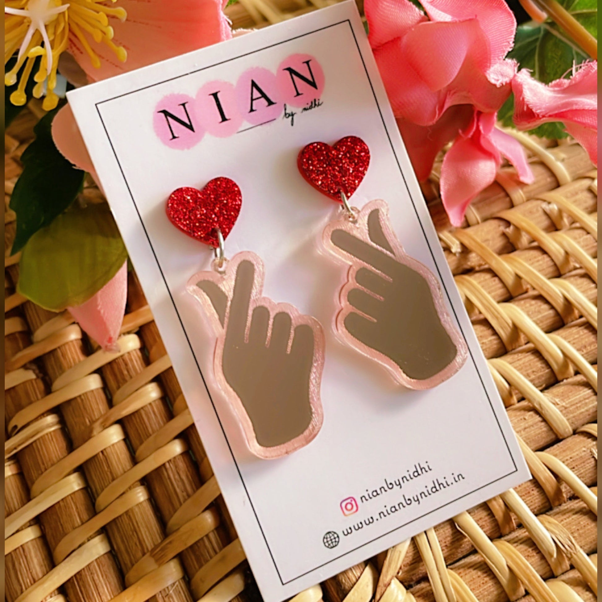 K-Pop Love Earrings - Rosegold and Red - Nian by Nidhi - placed in a yellow and pink background