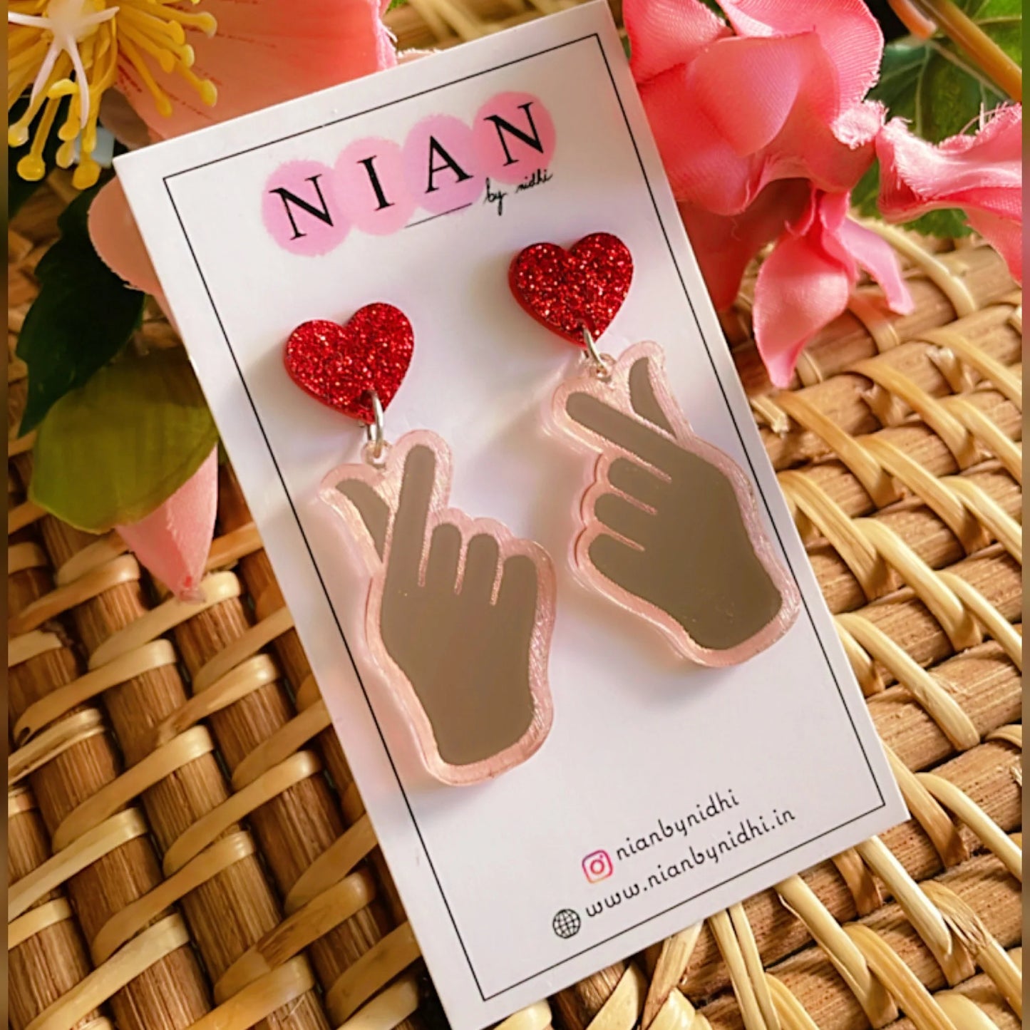 K-Pop Love Earrings - Rosegold and Red - Nian by Nidhi - placed in a yellow and pink background