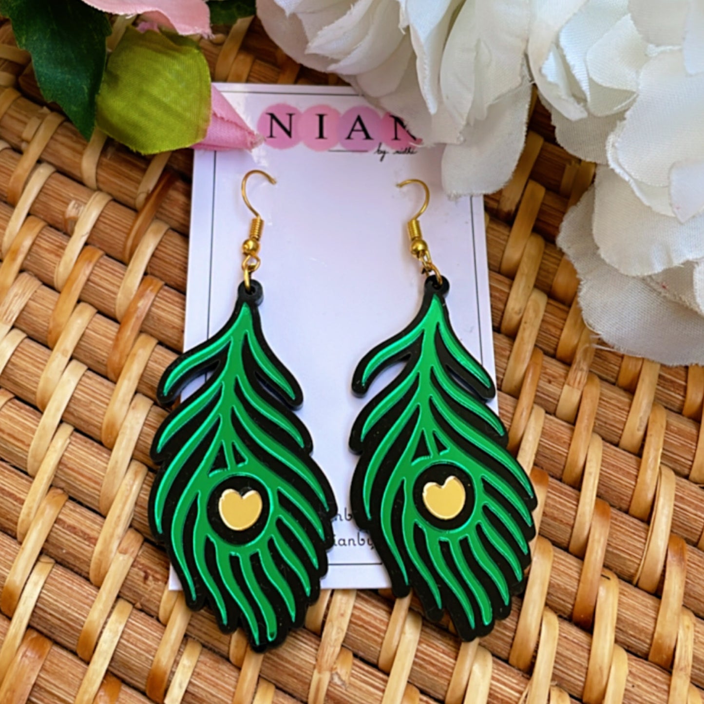 Morpankh Danglers - Glossy Green with Black and Golden details - Nian by Nidhi - placed in a brown background
