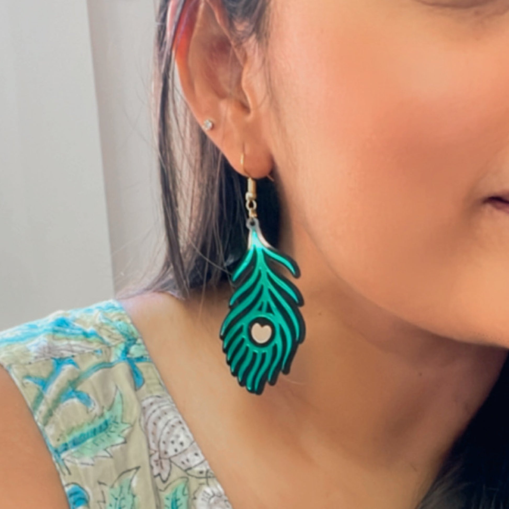 Morpankh Danglers - Glossy Green with Black and Golden details - Nian by Nidhi - worn by a woman