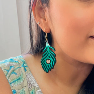 Morpankh Danglers - Glossy Green with Black and Golden details - Nian by Nidhi - worn by a woman