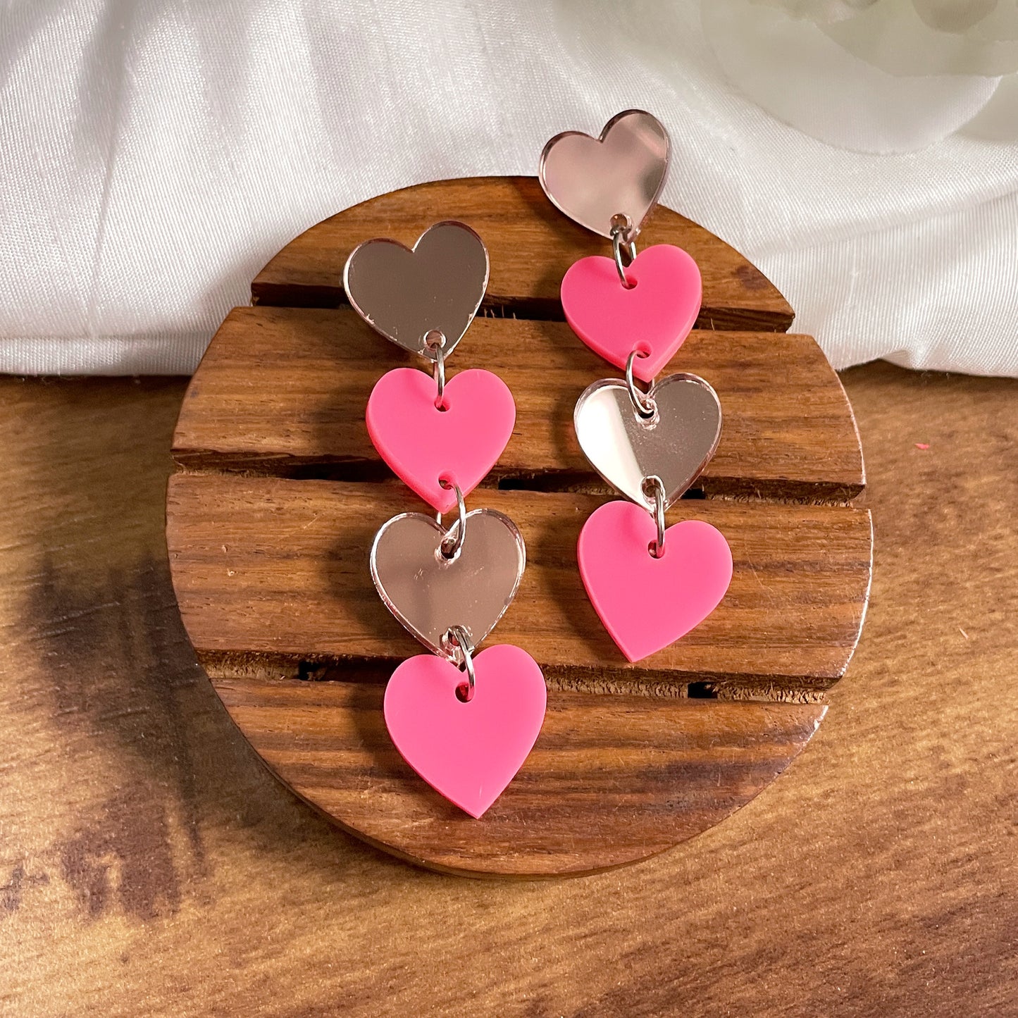 Little Heart Danglers - Nian by Nidhi - placed in a brown and white background