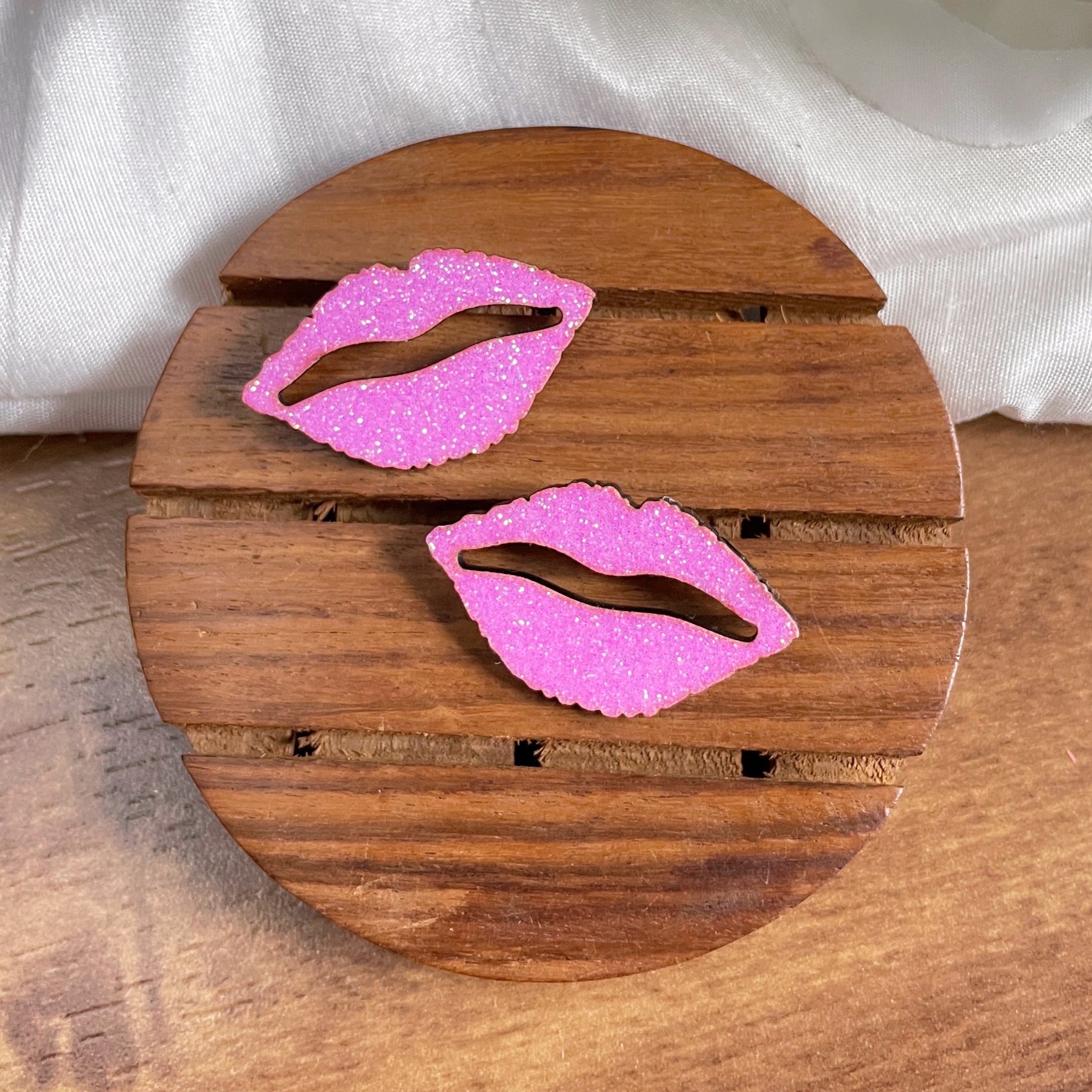 Shimmer Lips Studs (Pink) - Nian by Nidhi - placed in a brown and white background