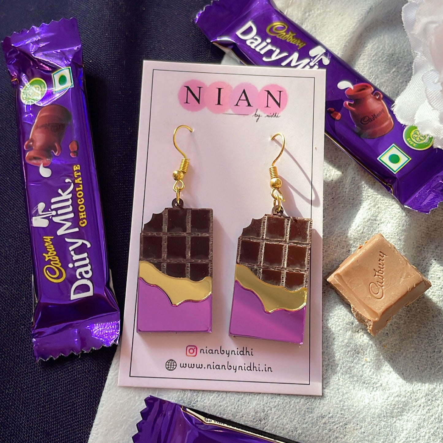 Choco Candy Earrings - Nian by Nidhi - placed in a white and blue background