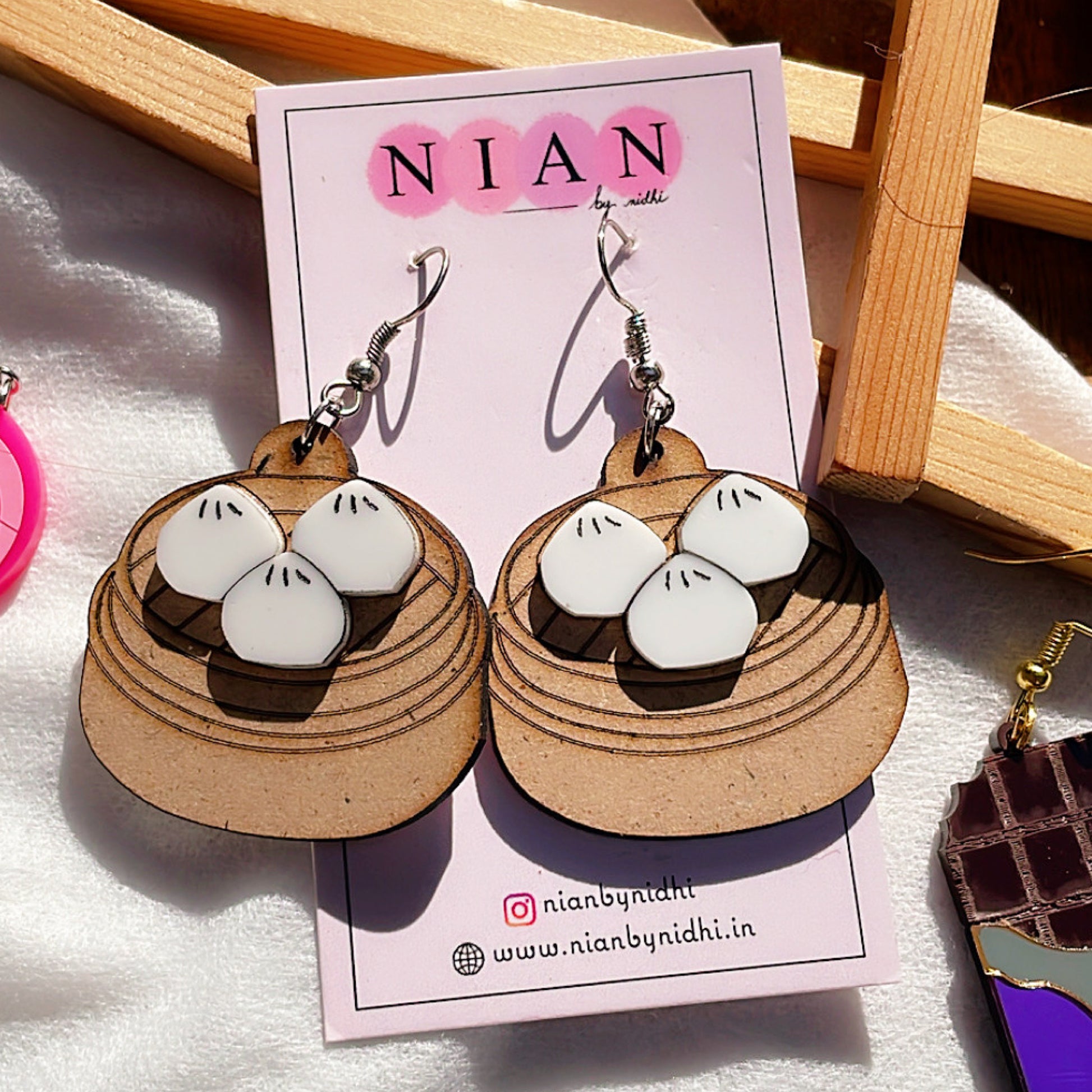 Momos Earrings - Nian by Nidhi - placed in a white and brown background