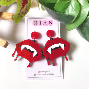 Bloody Lips Earrings - Red and White - Nian by Nidhi - placed in a white and green background
