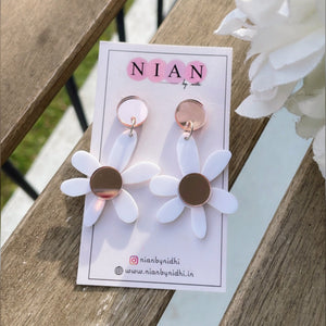 Lush Lily Earrings - White and Rosegold - Nian by Nidhi - placed in a white and rusty brown background