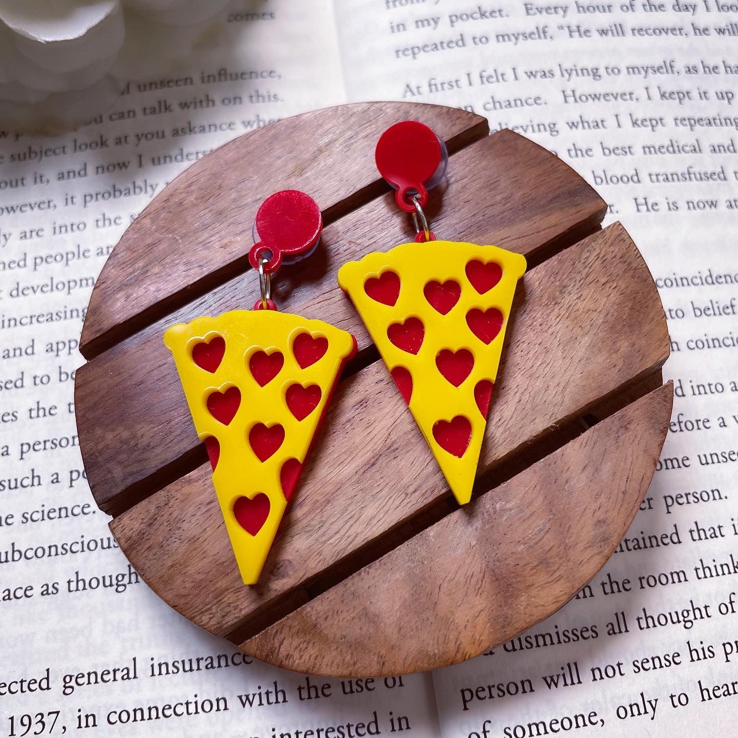 Pizza Earrings - Yellow and Red - Nian by Nidhi - in a background containing a white-paged book