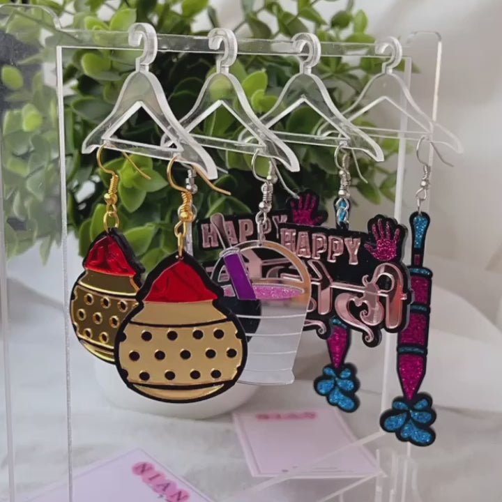 The Hanging Jewellery Organiser - Nian by Nidhi - placed with its 6 hangers and the Holi Hai! Combo that consists 4 earrings from Holi Special Collection