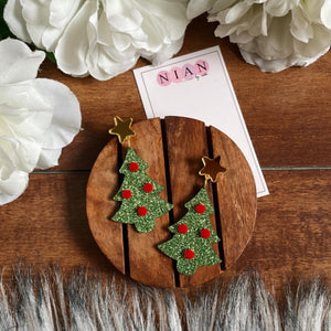 X-Mas Tree Earrings - Shimmer Green and Red - Nian by Nidhi - placed in a white and brown background, along with a Nian by Nidhi Earring Card