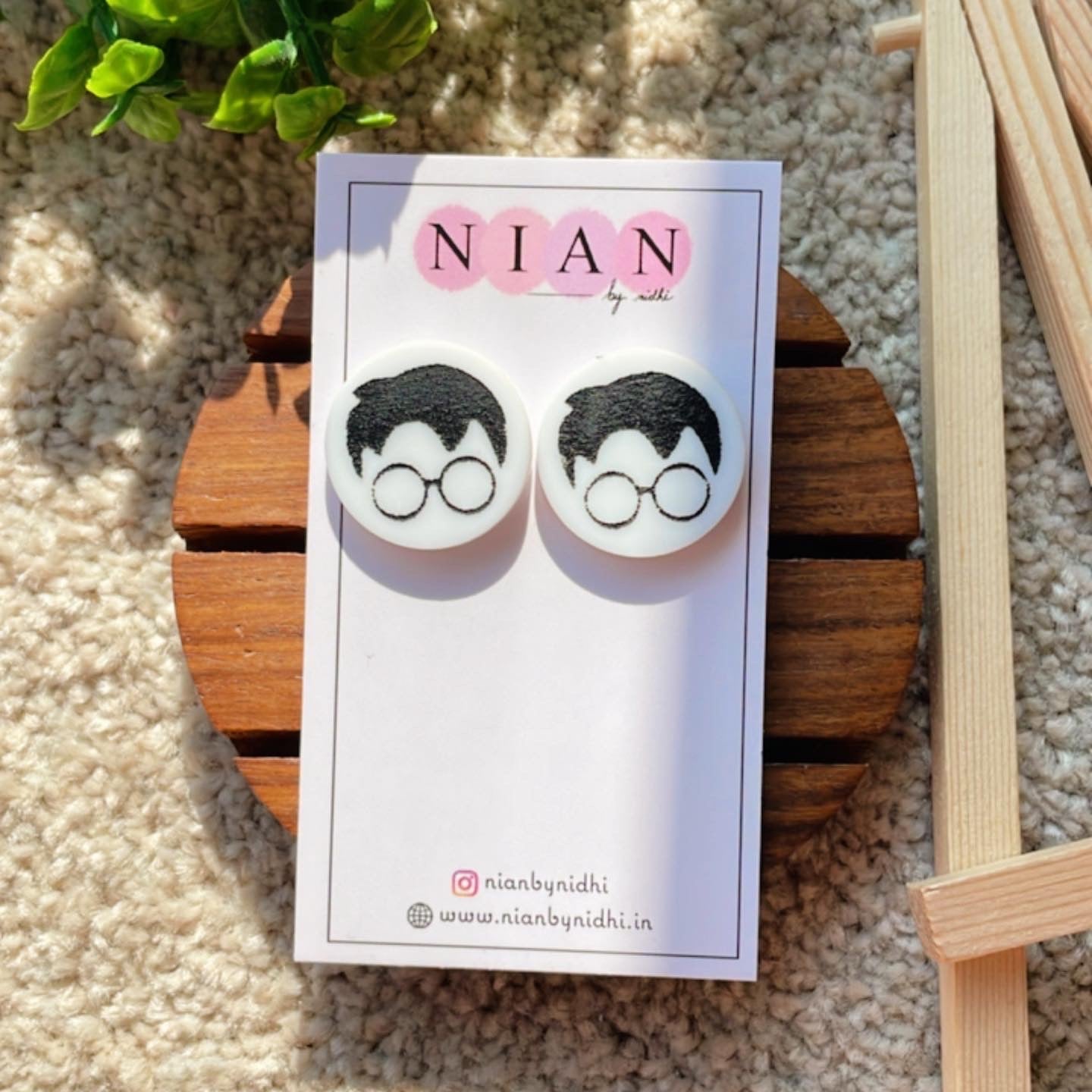 Harry Potter Face Studs - White and Black - Nian by Nidhi - placed on a Nian by Nidhi Earring card - in a light beige background