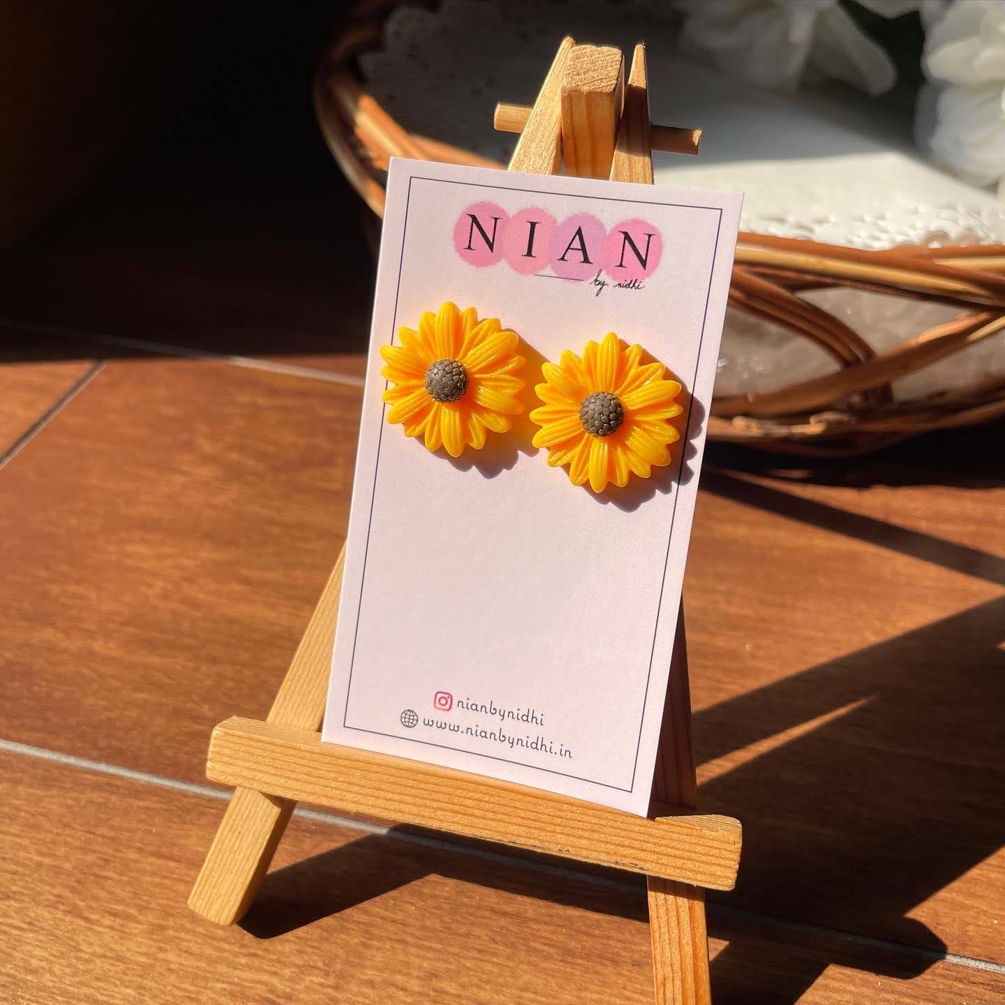 Sunkissed Sunflower Studs - Yellow - Nian by Nidhi - placed in a brown background