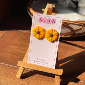 Sunkissed Sunflower Studs - Yellow - Nian by Nidhi - placed in a brown background