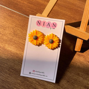 Sunkissed Sunflower Studs - Yellow - Nian by Nidhi - placed in a brown background