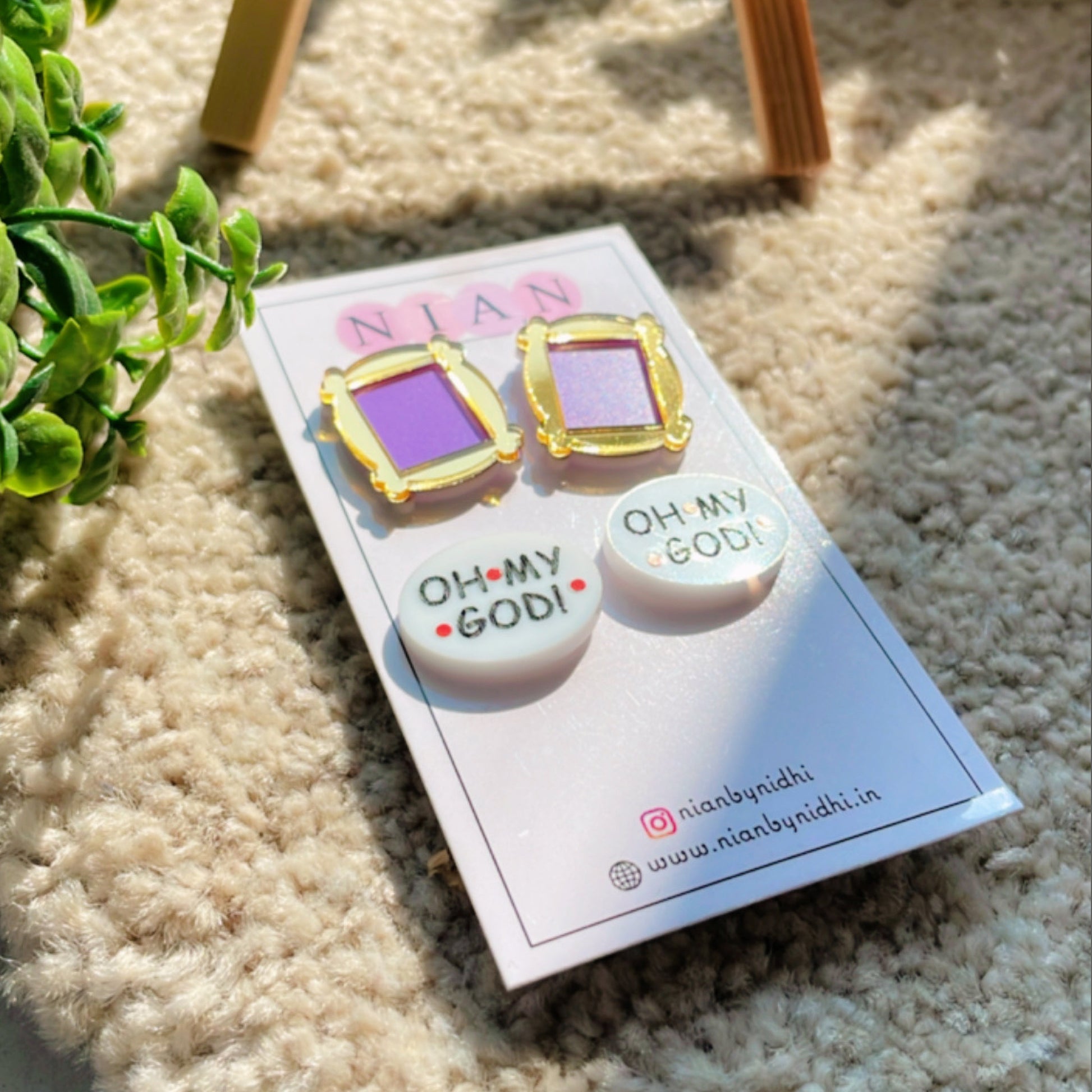 Friends Studs (Set of 2) - Monica's Frame Studs (Purple and Golden) + Oh My God Studs (White) - Nian by Nidhi - placed in a light beige background 