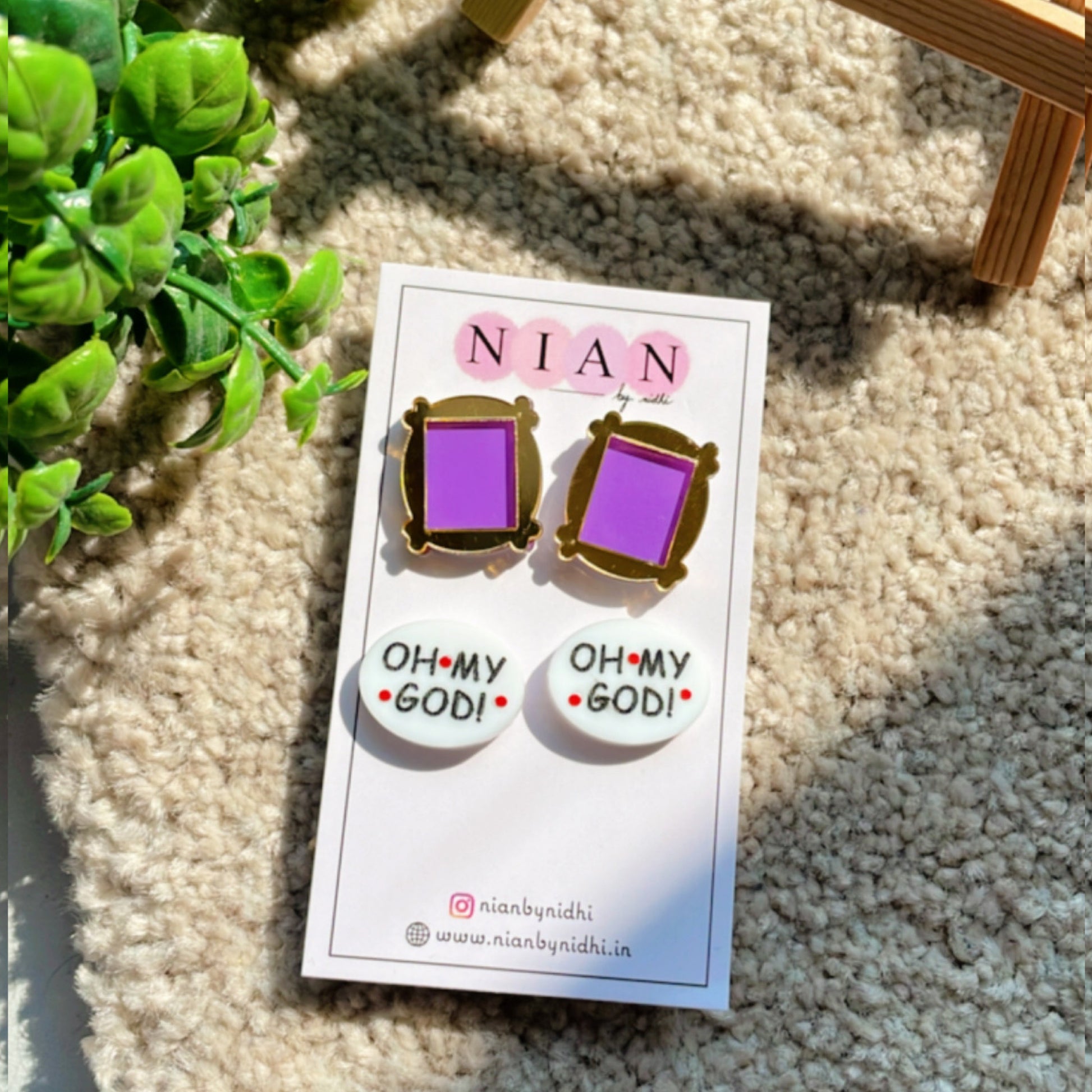 Friends Studs (Set of 2) - Monica's Frame Studs (Purple and Golden) + Oh My God Studs (White) - Nian by Nidhi - placed in a light beige background 