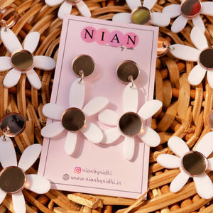 Lush Lily Earrings - White and Rosegold - Nian by Nidhi - placed in a brown basket along with other similar earrings