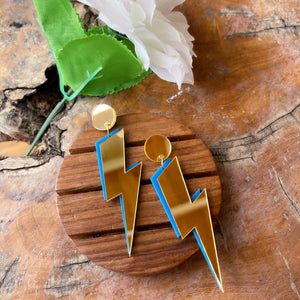 Lightning Earrings - Golden and Blue - Nian by Nidhi - in a white and brown background