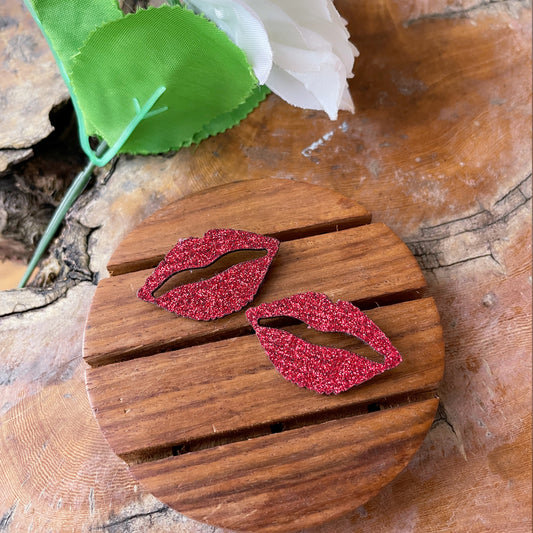 Shimmer Lips Studs - Red - Nian by Nidhi - in a white, green, and brown background