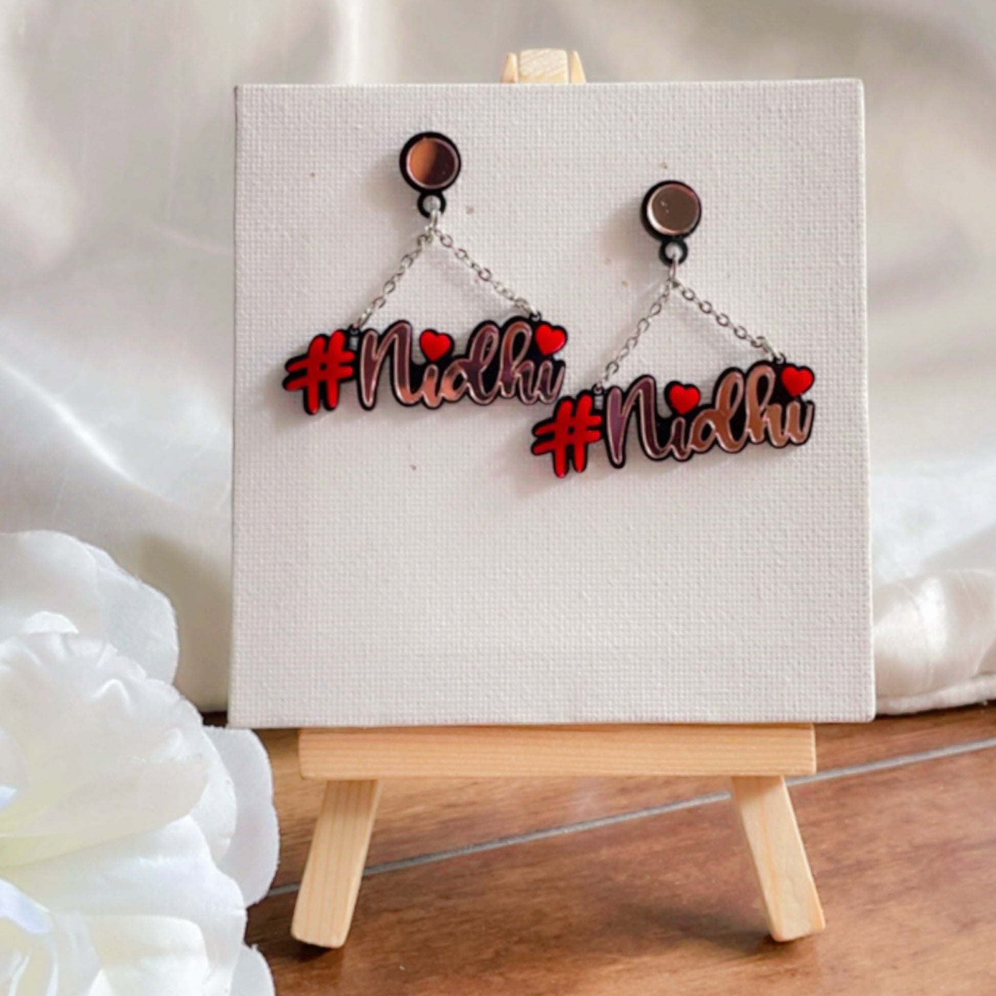 Customised Alphabet Earrings - personalised with a text - #nidhi - red and rose gold - Nian by Nidhi - placed on a small plain white canvas