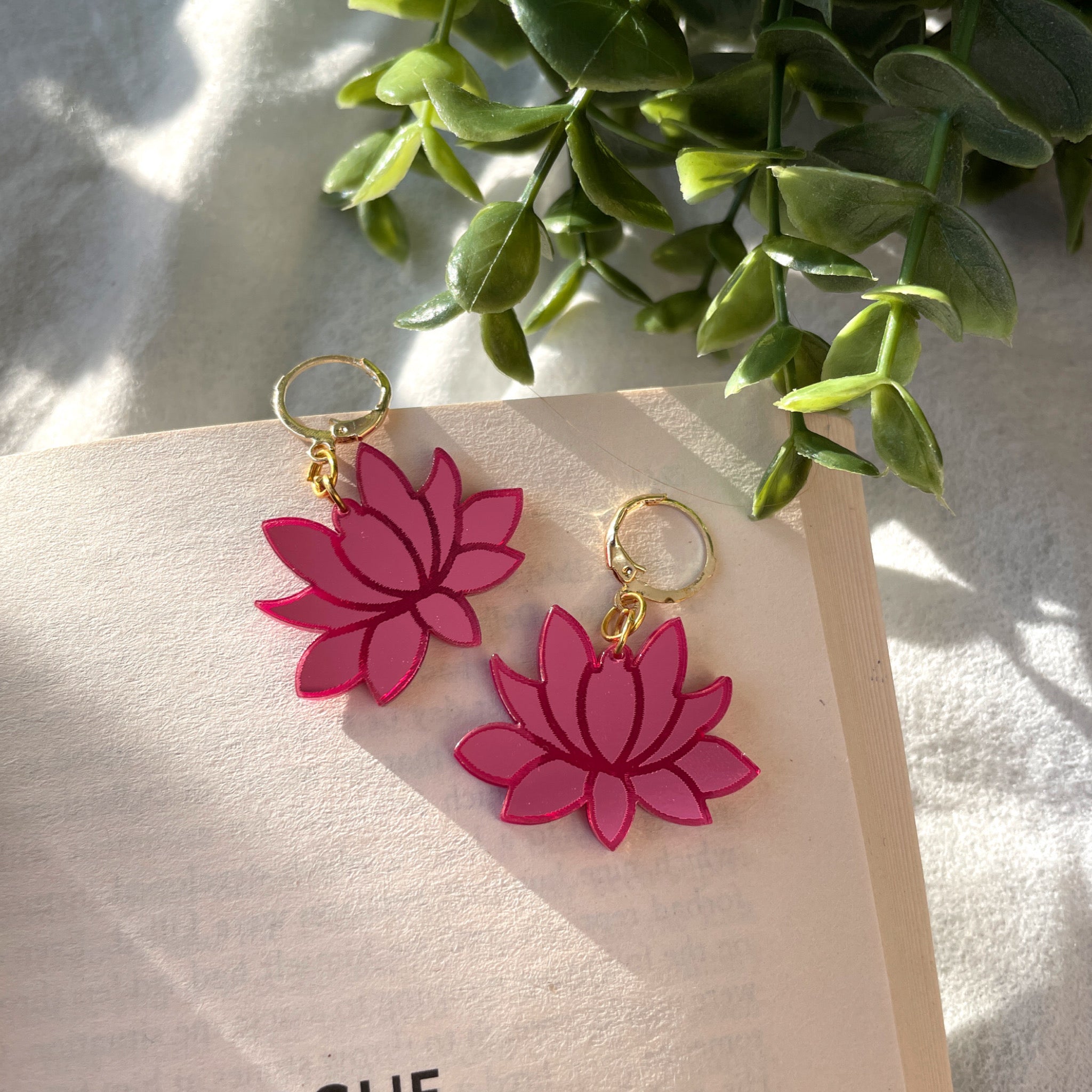 Lotus Danglers - Glossy Pink - Nian by Nidhi - placed in a white and green background