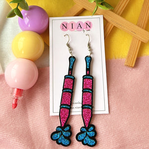 Rangon ki Pichkari Earrings - Shimmer Pink and Shimmer Blue - Nian by Nidhi - placed in a colorful background