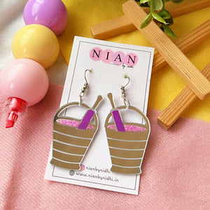 Rang Barse Earrings - Glossy Silver, Pink, and Purple - Nian by Nidhi - placed in a colorful backgroundRang Barse Earrings - Glossy Silver, Pink, and Purple - Nian by Nidhi - placed in a colorful background