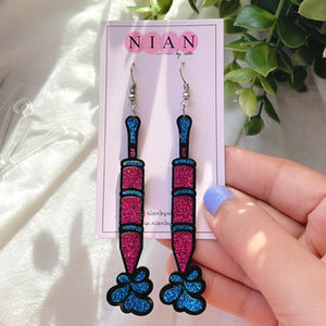 Rangon ki Pichkari Earrings - placed in a white and green background, held in a woman's hand