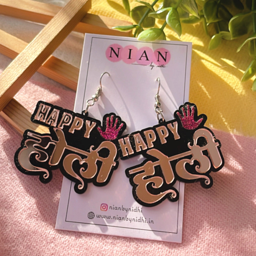 Happy Holi Earrings - Rosegold and Shimmer Pink - Nian by Nidhi - placed in a colorful background