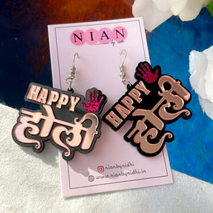 Happy Holi Earrings - Rosegold and Shimmer Pink - Nian by Nidhi - placed in a colorful background