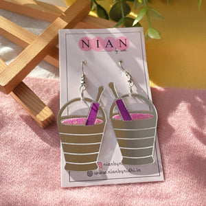 Rang Barse Earrings - Glossy Silver, Pink, and Purple - Nian by Nidhi - placed in a colorful background