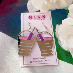 Rang Barse Earrings - Glossy Silver, Pink, and Purple - Nian by Nidhi - placed in a colorful background