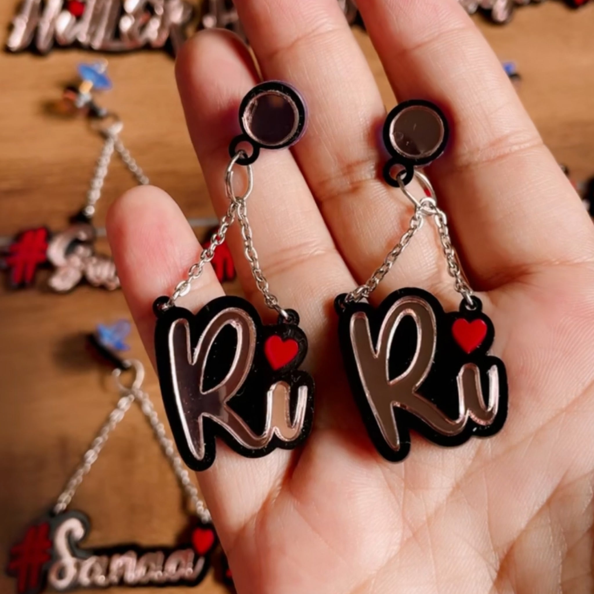 Customised Alphabet Earrings - personalised with a text - "Ri" - red and rose gold - Nian by Nidhi - in a brown background