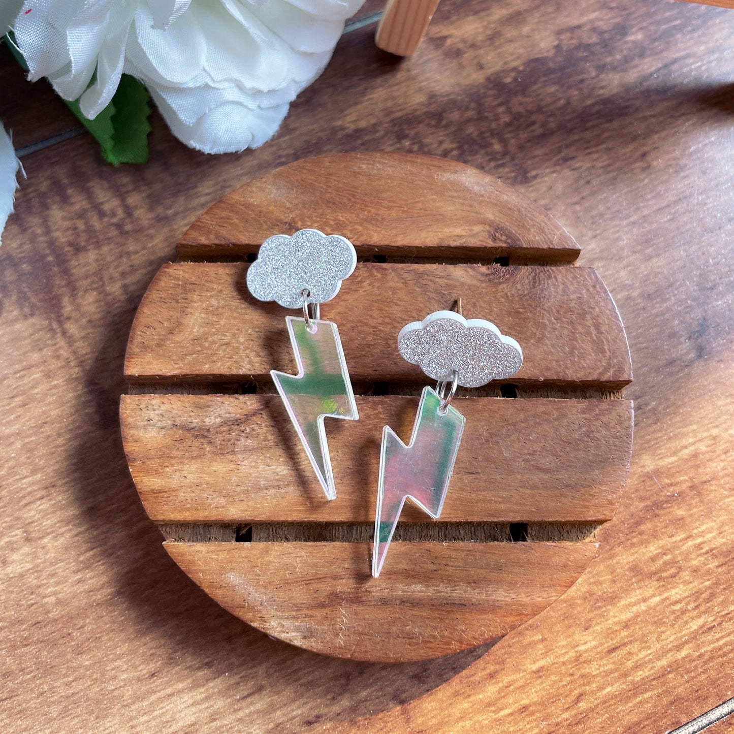 Thunder Cloud Earrings - Holographic and silver with shimmer - Nian by Nidhi - in a brown background