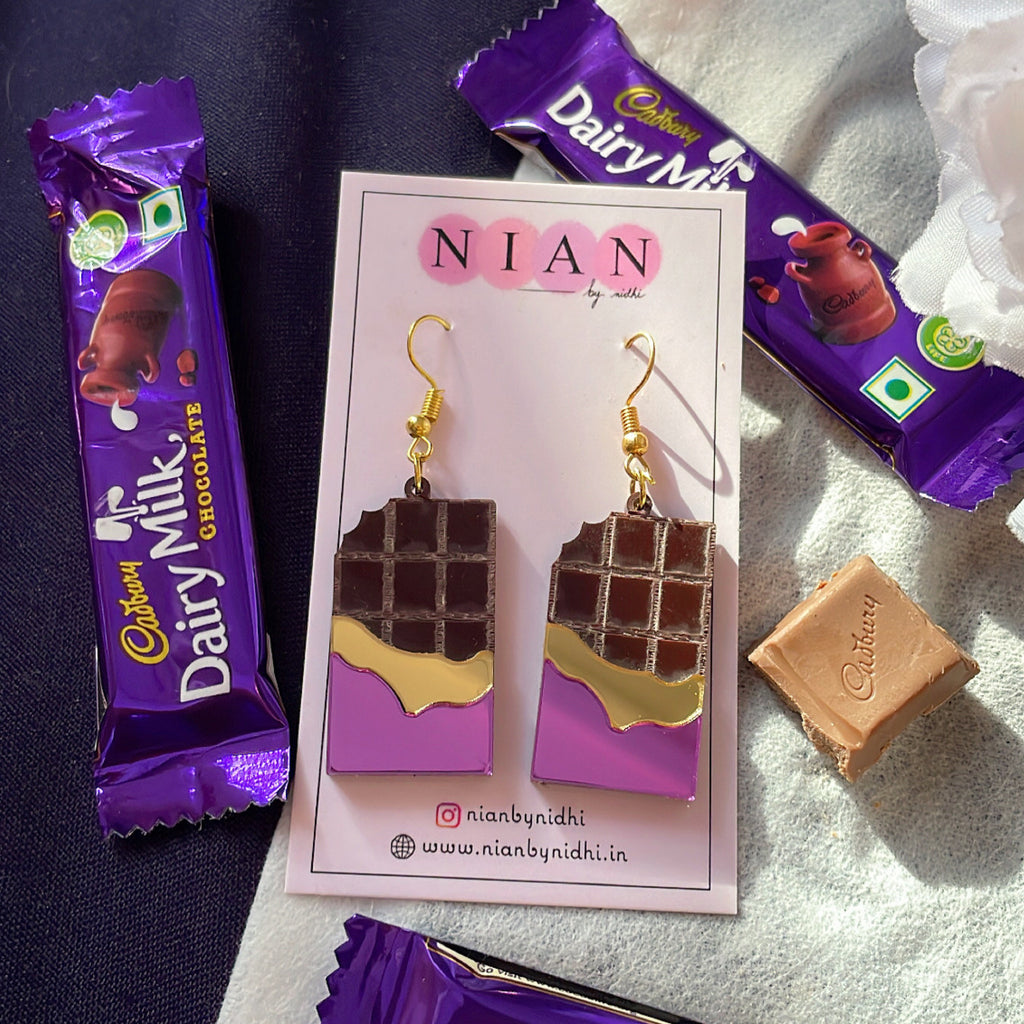 Choco Candy Earrings - Purple and Brown - Nian by Nidhi - placed in a white and blue background with Dairy Milk chocolates